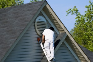 Painter working at roofline (landscape orientation)